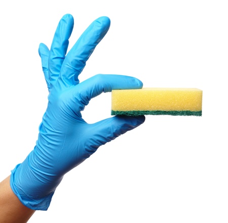 Hand in glove holding washing sponge, isolated over whiteの写真素材
