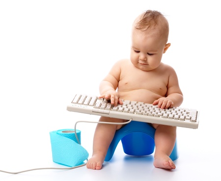 Little child is typing while sitting on potty, isolated over whiteの写真素材