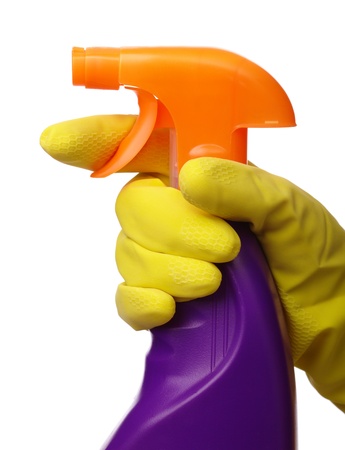 Chores - hand in yellow glove holds sprayer with chemical cleaner, isolated over whiteの写真素材
