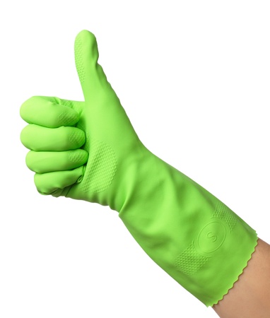 Hand wearing green rubber glove shows thumb up sign, isolated over whiteの写真素材
