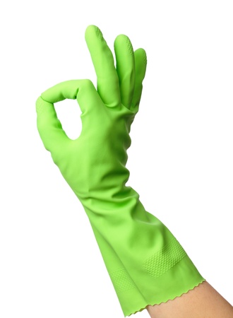 Hand wearing green rubber glove shows OK sign, isolated over whiteの写真素材