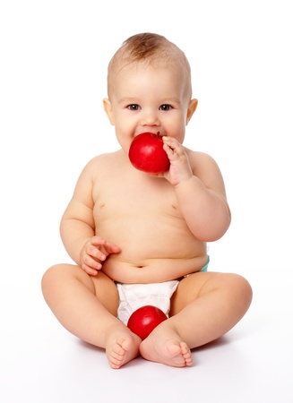 Portrait of a cute little child with two red apples, isolated over whiteの写真素材