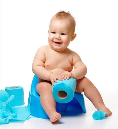 Child on potty play with toilet paper, isolated over whiteの写真素材