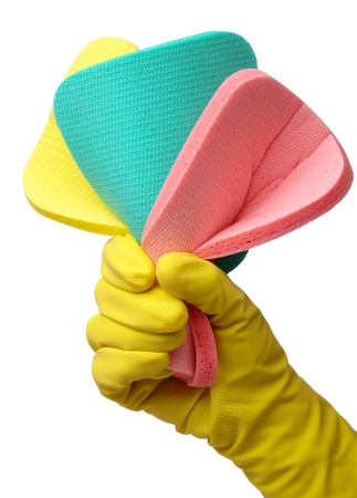 Few colorful washing sponges in hand wearing yellow glove, isolated over whiteの写真素材