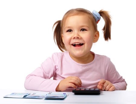 Happy little girl with few twenty euro banknotes, isolated over whiteの写真素材
