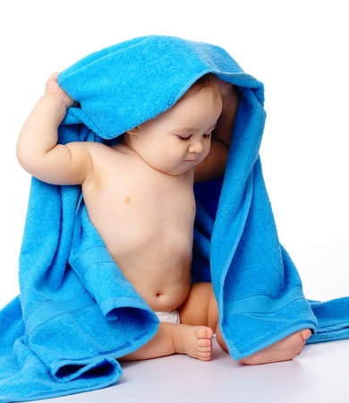 Cute little child wrapped in blue towel, isolated over whiteの写真素材