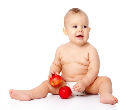 Portrait of a cute little child with two red apples, isolated over whiteの写真素材