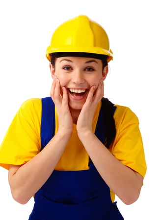 Young attractive construction girl holding her face in astonishment, isolated over whiteの写真素材