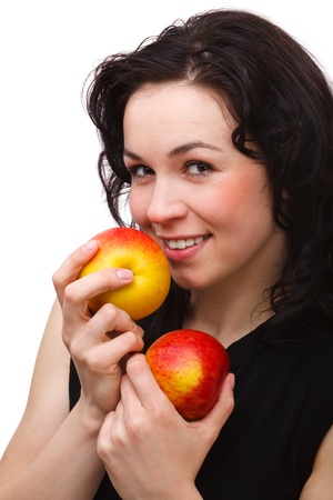 Portrait of a young attractive woman with two red apple, isolated over whiteの写真素材