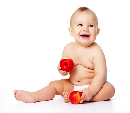 Portrait of a cute little child with two red apples, isolated over whiteの写真素材