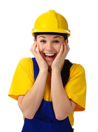 Young attractive construction girl holding her face in astonishment, isolated over whiteの写真素材