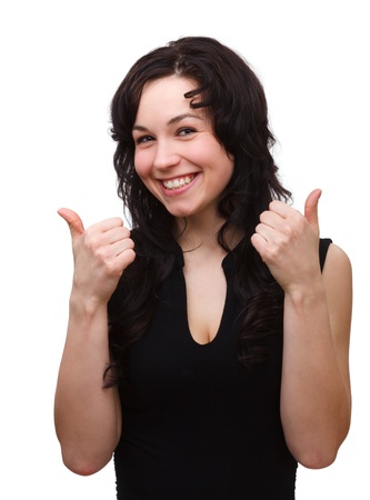 Young woman dressed in black is showing thumb up gesture, isolated over whiteの写真素材