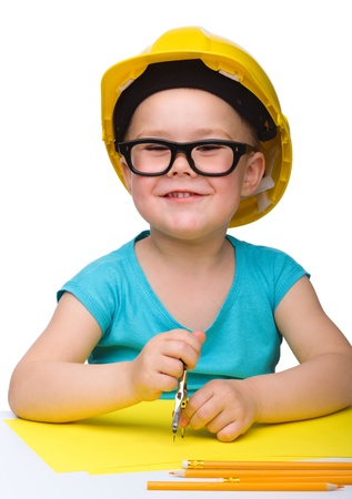 Cute little girl play with divider wearing hard hat, isolated over whiteの写真素材