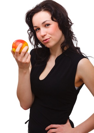 Portrait of a young attractive woman with red apple, isolated over whiteの写真素材