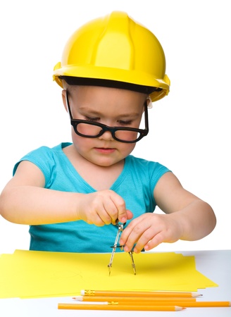 Cute little girl play with divider wearing hard hat, isolated over whiteの写真素材
