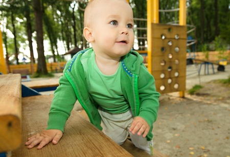 Cute little boy is playing on playgroundの写真素材