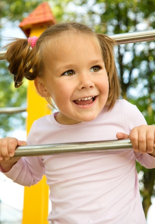 Cute little girl is playing in playgroundの写真素材