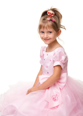 Cute little girl in pink dress, isolated over whiteの写真素材