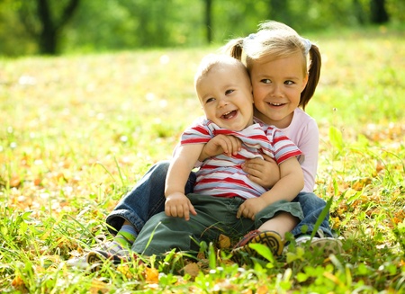Cute children are playing in autumn parkの写真素材