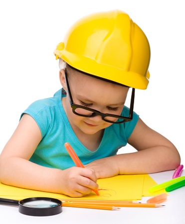 Cute little girl draw with marker wearing hard hat, isolated over whiteの写真素材
