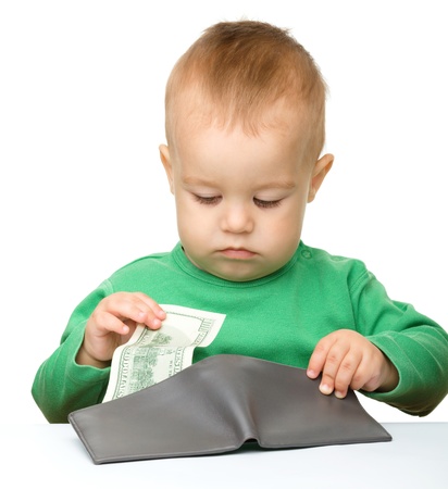 Cute little boy is counting money, isolated over whiteの写真素材