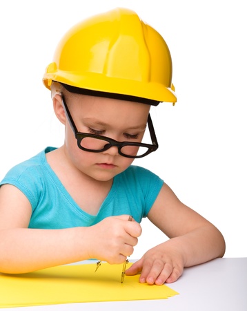 Cute little girl play with divider wearing hard hat, isolated over whiteの写真素材