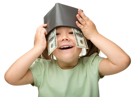 Cute cheerful little girl with paper money - dollars, isolated over whiteの写真素材