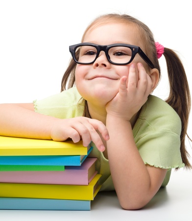 Cute little girl with books, isolated over whiteの写真素材