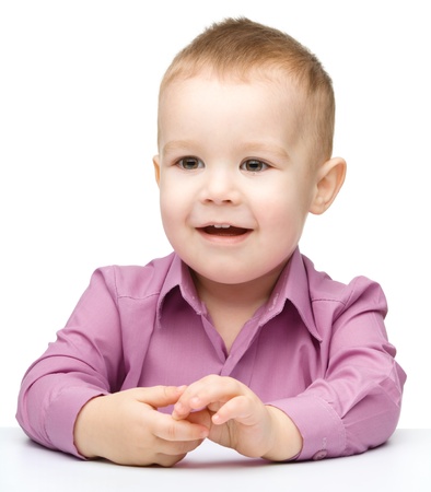 Portrait of a cute and pensive little boy, isolated over whiteの写真素材