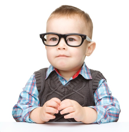 Portrait of a cute little boy wearing glasses, isolated over whiteの写真素材