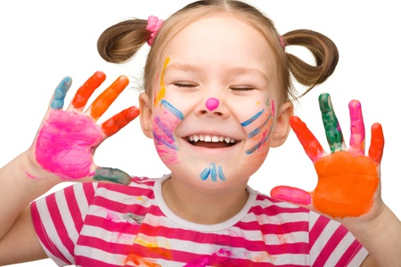 Portrait of a cute cheerful girl with painted hands closed her eyes in joy, isolated over whiteの写真素材