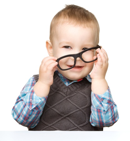 Portrait of a cute little boy wearing glasses, isolated over whiteの写真素材