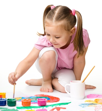 Cute cheerful child play with paints, isolated over whiteの写真素材