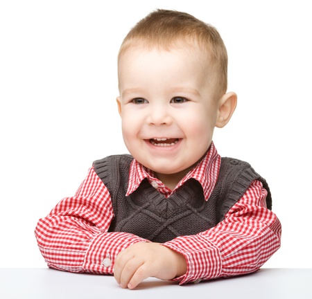 Portrait of a cute and cheerful little boy, isolated over whiteの写真素材