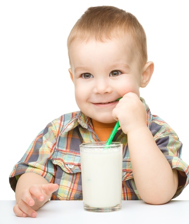 Cute little boy with a glass of milk, isolated over whiteの写真素材