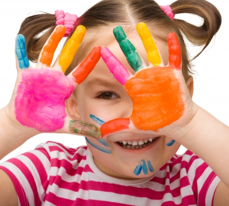 Portrait of a cute cheerful girl with painted hands, isolated over whiteの写真素材
