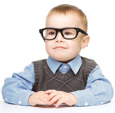 Portrait of a cute little boy wearing glasses, isolated over whiteの写真素材