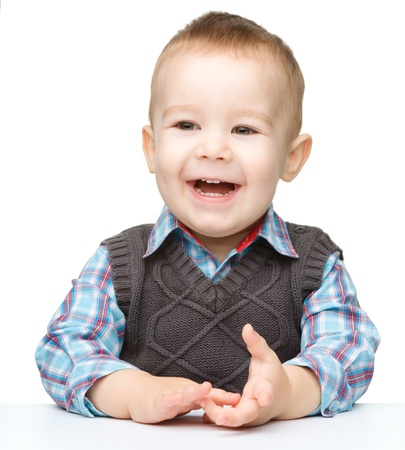 Portrait of a cute and cheerful little boy, isolated over whiteの写真素材