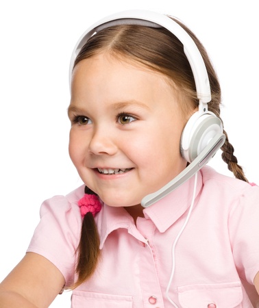 Cute young girl is working as an operator at helpline talking with customer using headset, isolated over whiteの写真素材