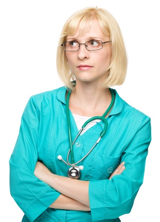 Portrait of a young attractive woman wearing doctor uniform and glasses, isolated over whiteの写真素材