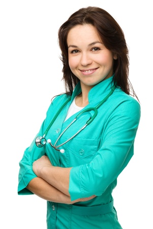 Portrait of a young attractive woman wearing doctor uniform, isolated over whiteの写真素材