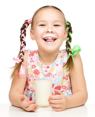 Cute little girl showing milk moustache, isolated over whiteの写真素材
