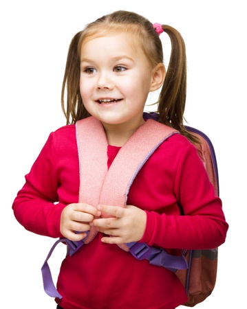Portrait of a cute little schoolgirl with backpack, isolated over whiteの写真素材
