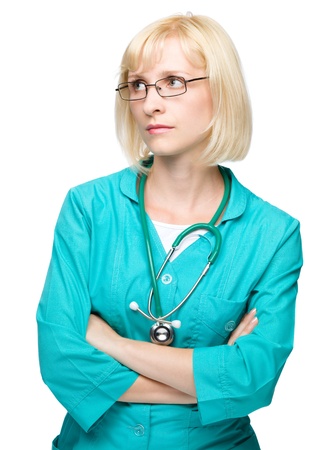Portrait of a young attractive woman wearing doctor uniform and glasses, isolated over whiteの写真素材
