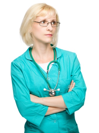 Portrait of a young attractive woman wearing doctor uniform and glasses, isolated over whiteの写真素材