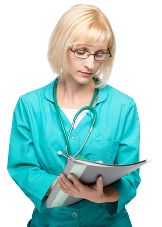 Portrait of a young attractive woman wearing doctor uniform and glasses writing prescription, isolated over whiteの写真素材