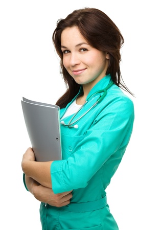 Portrait of a young attractive woman wearing doctor uniform, isolated over whiteの写真素材