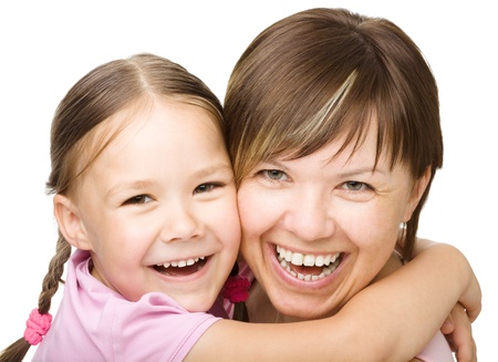 Portrait of a happy daughter embracing her mother, isolated over whiteの写真素材