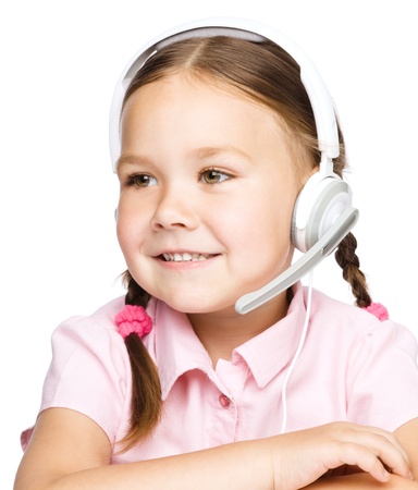 Cute young girl is working as an operator at helpline talking with customer using headset, isolated over whiteの写真素材