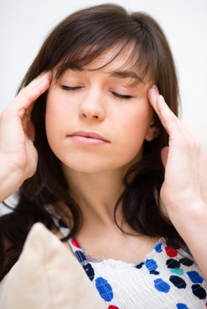 Young woman is suffering headacheの写真素材